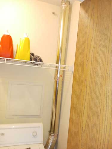 Dryer vent line routed through a residential laundry room