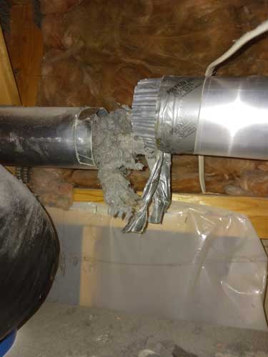 Dryer vent duct packed with lint at a disconnected joint
