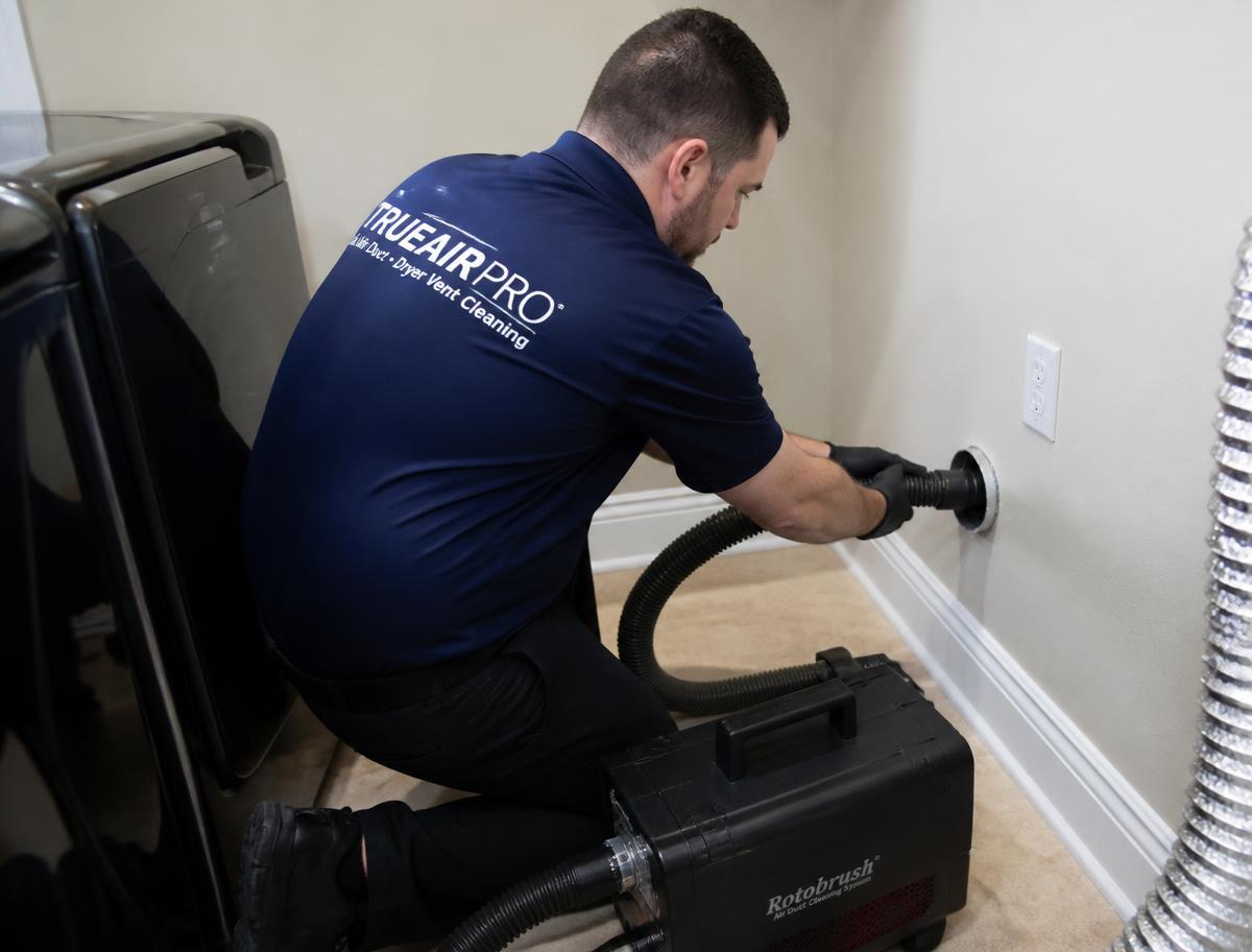 TRUEAIR PRO dryer vent cleaner removing lint from a dryer vent line with professional equipment